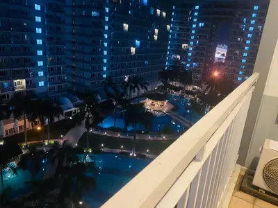 a view of a pool from the balcony of a building at Shell Residences C21 Shortwalk Sm Mall Of Asia Airport in Manila