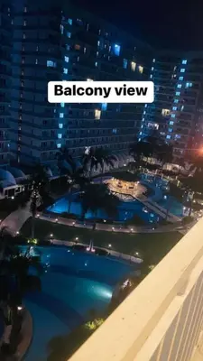 a view of a swimming pool in a city at night at Shell Residences C21 Shortwalk Sm Mall Of Asia Airport in Manila