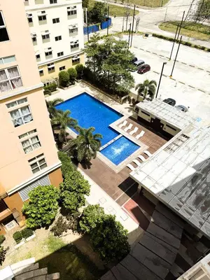 an overhead view of a swimming pool in front of a building at JFam Suites, C3-11D Studio, Up To 4 Pax in Biñan