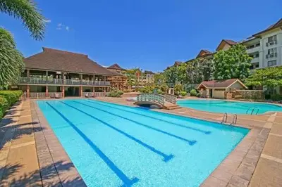 a large swimming pool in front of a building at Condo in Pasig - One Oasis Staycation in Manila