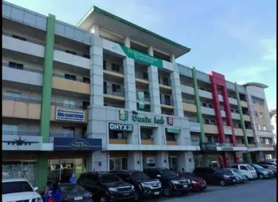 a large building with cars parked in front of it at Condo in Pasig - One Oasis Staycation in Manila