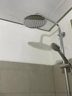 a shower head on the ceiling of a bathroom at Makati Cozy Studio Apartment in Manila