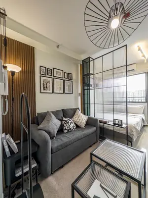 a living room with a couch and a bed at GemstoneBR in SMDC Shore 2 Residences in Manila