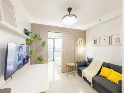 a living room with a couch and a tv at GemstoneBR in SMDC Shore 2 Residences in Manila