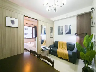 a living room with a couch and a bed at GemstoneBR in SMDC Shore 2 Residences in Manila