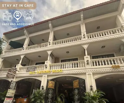 a white building with a balcony on top of it at Cinema room at Intramuros by IN cafebar in Manila
