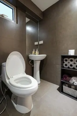 a bathroom with a toilet and a sink at One bedroom budget condo in BGC in Manila