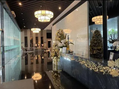 a lobby with a christmas tree on the wall at Cozy Condo Apartment in Makati / Manila with mall, restaurants, groceries, pool, netflix, disney+ and more in Manila