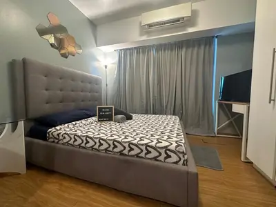 a bedroom with a bed with a laptop on it at DFT Apartment 