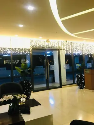 a lobby of a building with a room with windows at Spring Residences Affordable Condotel Bicutan Paranaque near NAIA Airport in Manila