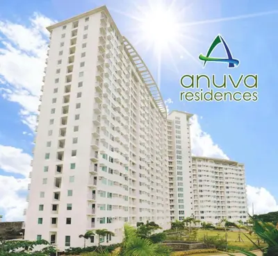 a large white building with the amuvores logo on it at Ultimate getaway in Alabang at Anuva Residences in Manila