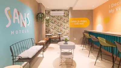 a barber shop with chairs and tables in a store at Sans Hotel at One JD Place Makati by RedDoorz in Manila