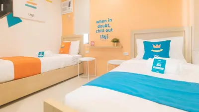a kids room with two beds and a sign that reads when in doubt call out at Sans Hotel at One JD Place Makati by RedDoorz in Manila