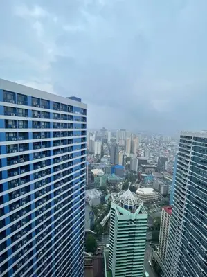 an aerial view of a city with tall buildings at Cozy Family Nook at Makati in Manila