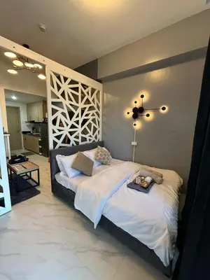 a bedroom with a large bed with a tray on it at Jamellas' Smile Home in Manila