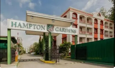 a building with a sign that reads hampton gardens at Nathan's Staycation in Manila
