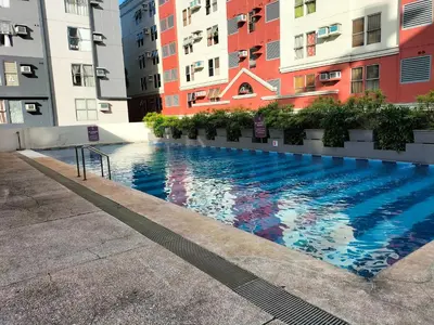 a swimming pool in the middle of some buildings at Nathan's Staycation in Manila