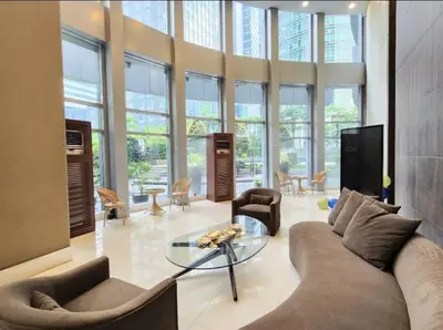 a living room with a couch and a glass table at BGC Avant at The Fort Cosy and Vibrant 2BR near Burgos Circle in Manila