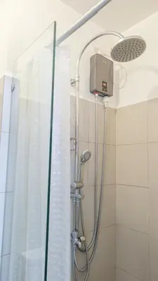 a shower with a shower head in a bathroom at Casa Roma Manila in Manila
