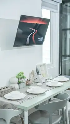a white table with white chairs and a window at Casa Roma Manila in Manila