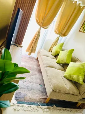 a couch sitting in a living room with a window at Chic and Cozy 1BR Shore 3 by SMDC near MOA in Manila