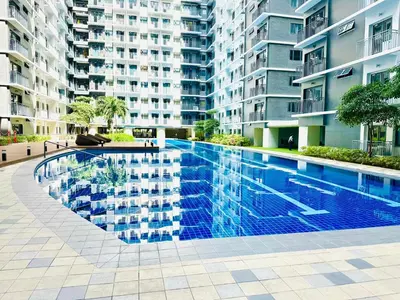 a swimming pool in the middle of a building at Chic and Cozy 1BR Shore 3 by SMDC near MOA in Manila