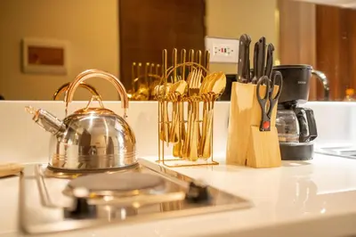 a kitchen counter with a tea kettle and utensils at House of Tulips in Air Residences Makati City in Manila