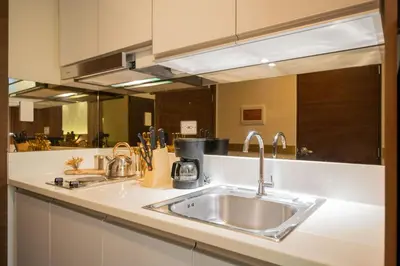 a kitchen with a sink and a counter top at House of Tulips in Air Residences Makati City in Manila
