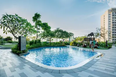 a swimming pool with people playing in it at House of Tulips in Air Residences Makati City in Manila