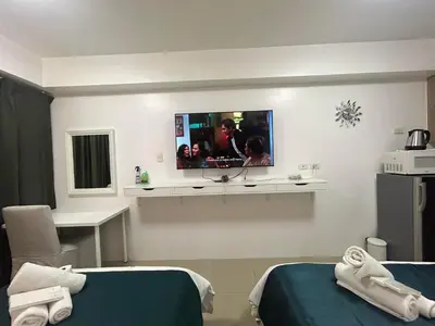a hospital room with two beds and a tv on the wall at MALL OF ASIA 1156 Affordable Staycation DYNASTEL SHORE in Manila
