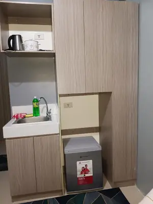 a small kitchen with a sink and a trash can at K2K place in Manila