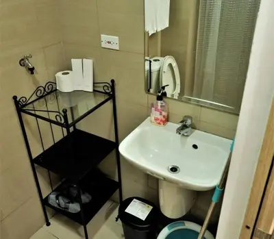 a small bathroom with a sink and a mirror at WORLD TRADE CENTER 959 DYNASTEL SHORE Staycation in Manila