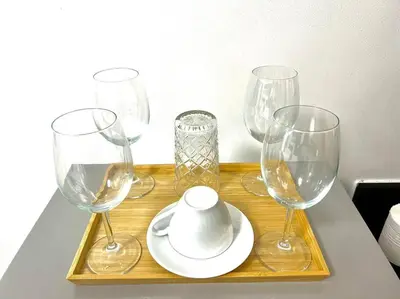 a group of wine glasses and a plate on a table at WORLD TRADE CENTER 959 DYNASTEL SHORE Staycation in Manila