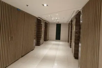 a hallway of a building with wooden walls and a white tile floor at BAY WALK MANILA 957 DYNASTEL SHORE Staycation in Manila