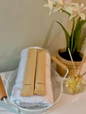 a couple of towels sitting on a glass table at Condotel Across Naia T3 at ONE PALM TREE VILLA CLUSTER B in Manila