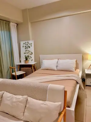 a bedroom with two beds and a couch at Condotel Across Naia T3 at ONE PALM TREE VILLA CLUSTER B in Manila