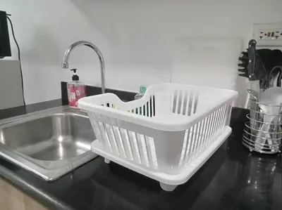 a white dish basket sitting on top of a kitchen counter at Philippine International Convention Center 676 DYNASTEL SHORE in Manila
