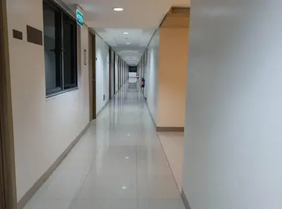 an empty hallway of a building with a long corridor at DYNASTEL SHORE 635 MOA Pasay Staycation in Manila