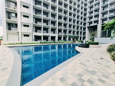 a swimming pool in front of a building at CONDOTEL STAYCATION 793 Pasay DYNASTEL in Manila