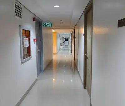 a hallway in a hospital with a long corridor at DYNASTEL 787 SHORE Staycation in Manila