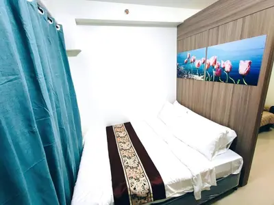 a bedroom with a bed with a picture on the wall at NAIA AIRPORT MOA 1278 DYNASTEL SHORE Staycation in Manila