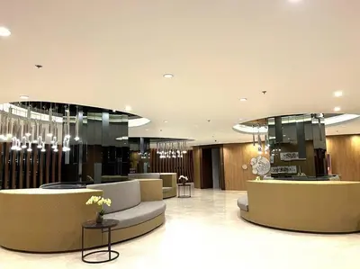 a lobby with couches and chandeliers in a building at MOA PASAY 1478 Dynastel Shore Staycation in Manila