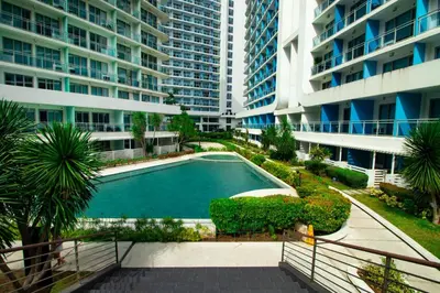 an empty swimming pool in the middle of a building at Cozy Chic Condotel Azure Urban Resort Residences in Manila