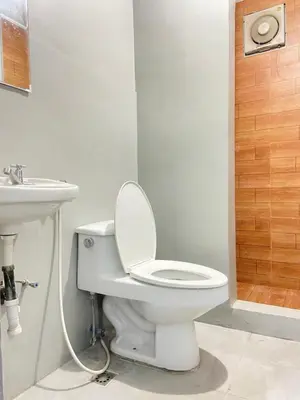 a bathroom with a toilet and a sink at Lime Lite Manila Hostel in Manila