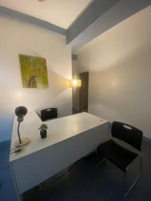 a white desk with two chairs and a lamp at Lime Lite Manila Hostel in Manila