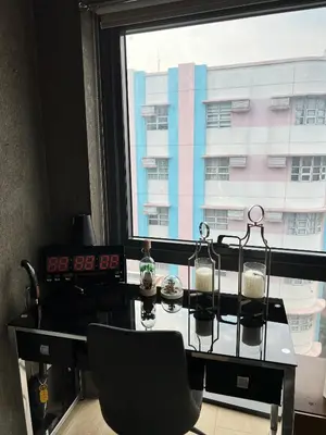 a glass table and a chair in front of a window at Modern Studio at NAIA Terminal 3 in Manila