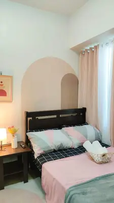 a bedroom with a bed and a desk and a bed sidx sidx sidx at anuva residences room 1 in Manila