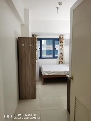 a small bedroom with a bed and a window at GRAND RIEVERA SUiTES in Manila