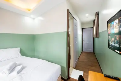 a bedroom with a bed and a desk with a computer at St. Marvin Studio Makati M405 in Manila