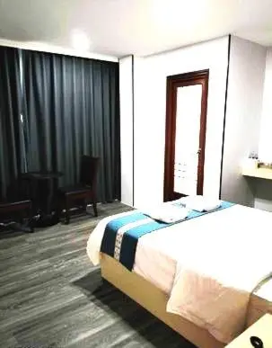 a hotel room with a bed and a window at Venice Star Grand Hotel in Manila